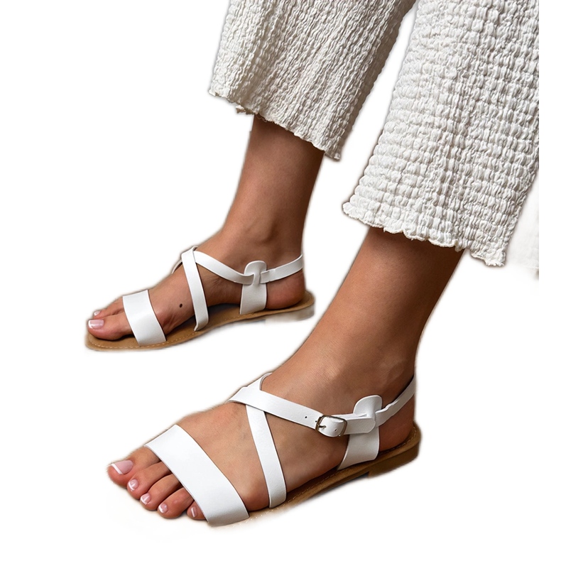 White flat sandals with a belt