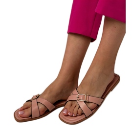 Pink flip flops with a decorative buckle on the belt Pink flip flops with a decorative buckle on the belt