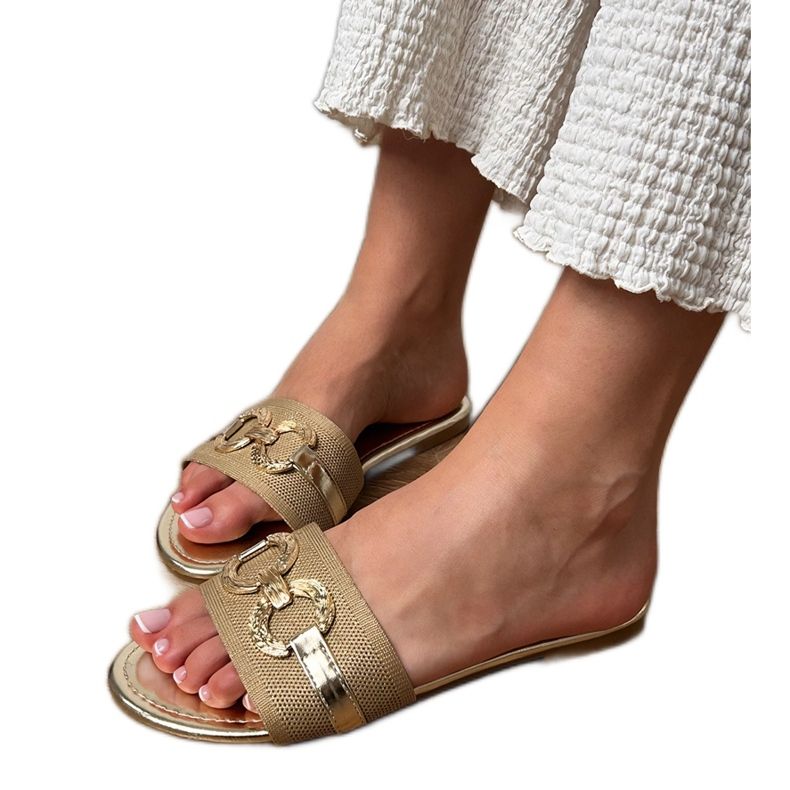 Golden flip flops with a golden decoration on the belt Golden flip flops with a golden decoration on the belt
