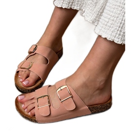 Pink flip flops with clamps on a cork sole