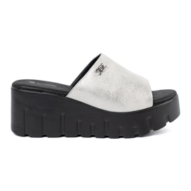 Goodin Silver flip flops on a black platform