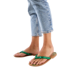 Green flip flops decorated with pebbles