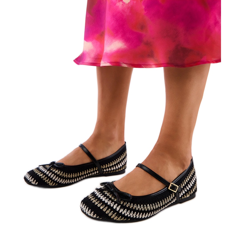 Black material ballerinas with a buckle and a bow