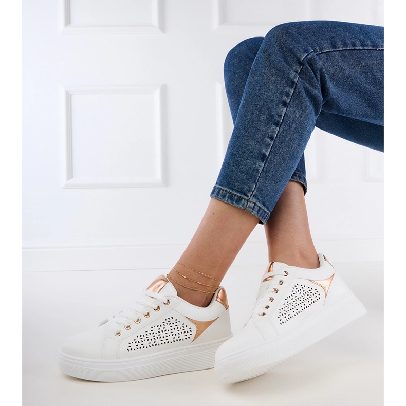 White sneakers with gold inserts on the platform