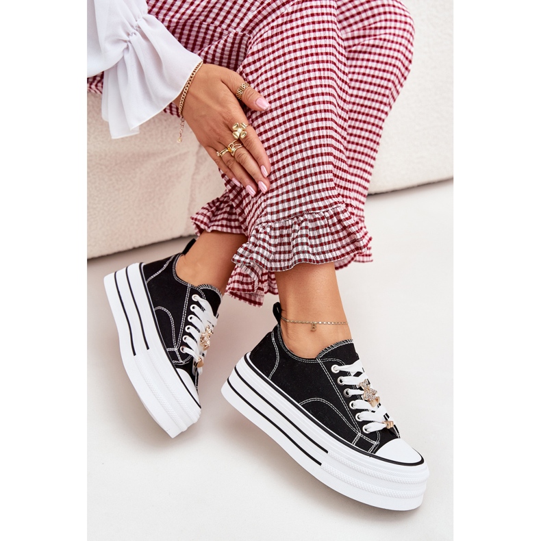 Women's sneakers on the platform with golden pins black