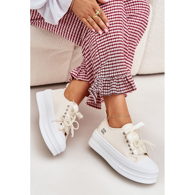 Women's sneakers on the platform with decorative lacing beige
