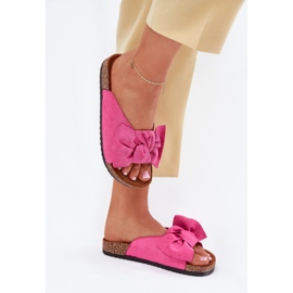 Women's flip flops on a cork sole with a bow of fuchsia pink