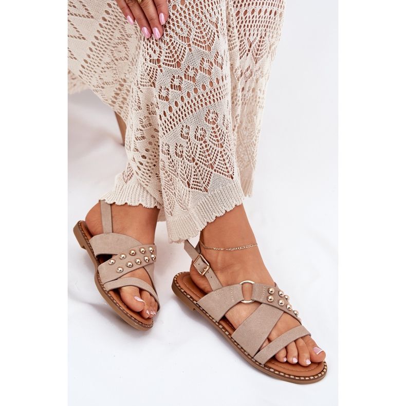 Flat -heeled women's sandals with golden studs beige