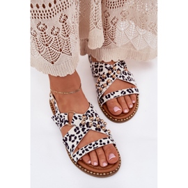 Flat-heeled women's sandals with golden-white studs