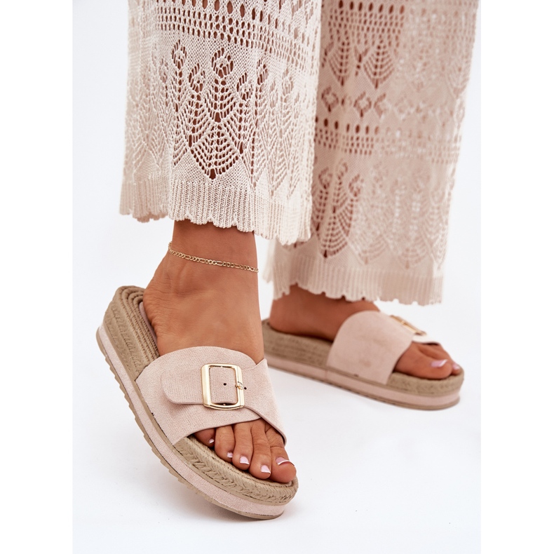 Women's slippers on the platform with a golden clamp beige