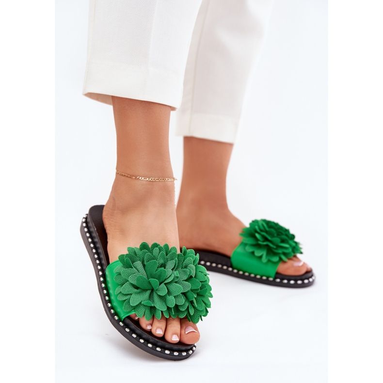 Women's flip flops decorated with green flowers