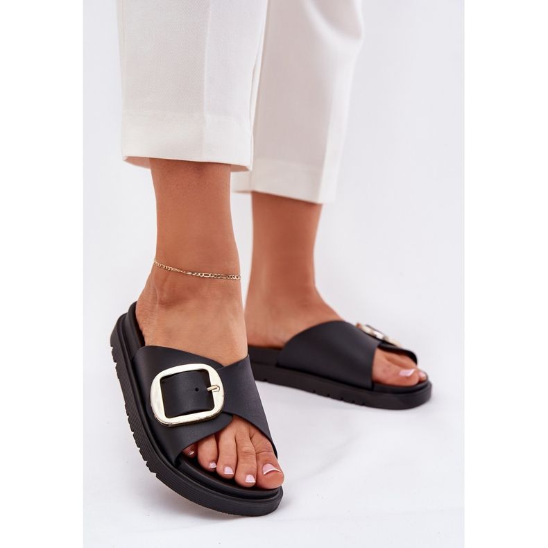 Women's flip flops on the platform with a golden clamp black