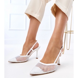 White sandals on a high heel decorated with lior zircons White sandals on a high heel decorated with lior zircons