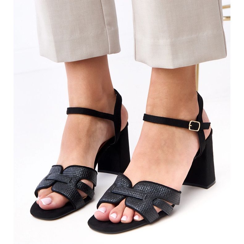 Black sandals on the post fastened on the Farida cube