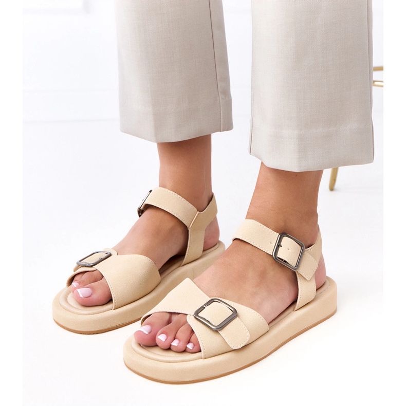 Beige sandals with a buckle on the Mirkas bar