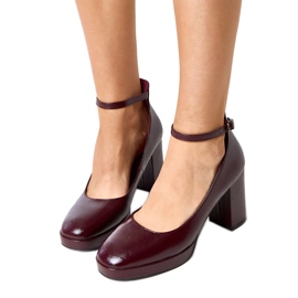 Burgundy pumps varnished on a massive batuma post red