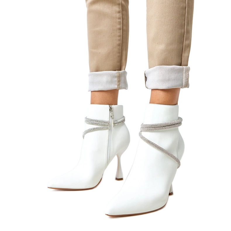 White boots on a high heel decorated with fantaro zircons