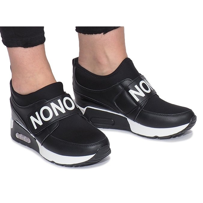 Black sports sneakers on the Monon wedge