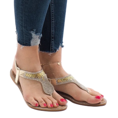 Golden flip-flops decorated with B012