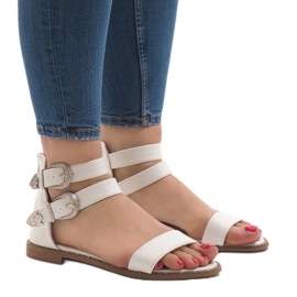 White flat sandals with a 170 buckle