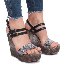 Black sandals on a Trout wedge