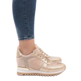 Golden sneakers on the wedge G-125