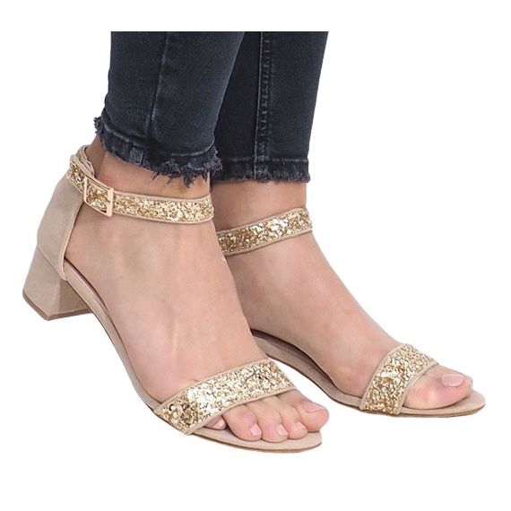 Gold sandals on a Montana post golden yellow