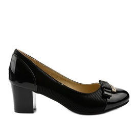 Ladies' black pumps on a Greenbane post