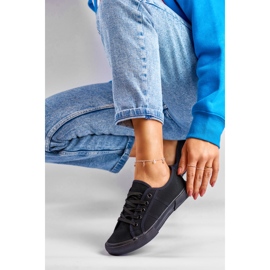 Black low-top sneakers with a black sole 1