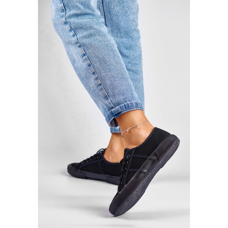 Black low-top sneakers with a black sole 2