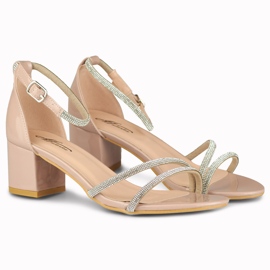 Elegant shiny beige women's sandals on the post 2