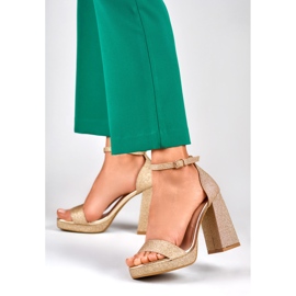 Gold shiny sandals on a wide high heel golden 2