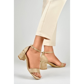 Beige sandals on a low heel with a golden detail 1