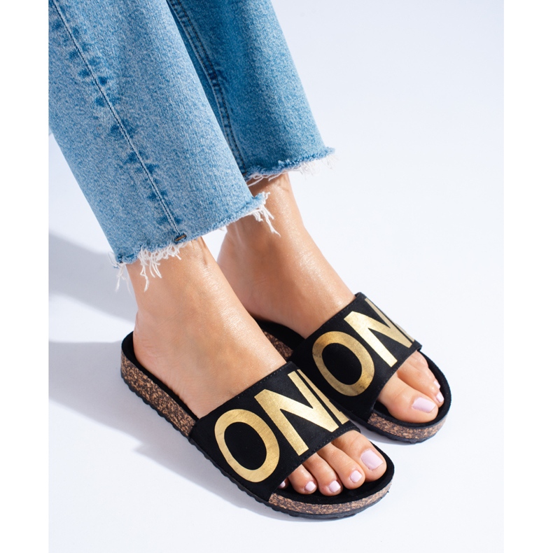 Black flip-flops with gold lettering on the Shelovet cap 1