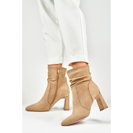 Ladies' beige boots on a decorated post 2