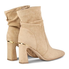 Ladies' beige boots on a decorated post 1