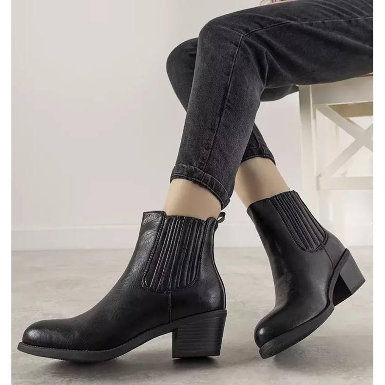 Black slip-on ankle boots on the Pena post 1