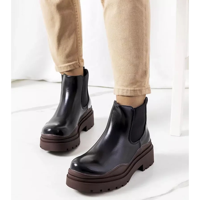 Black ankle boots on a brown Gaffney platform 1