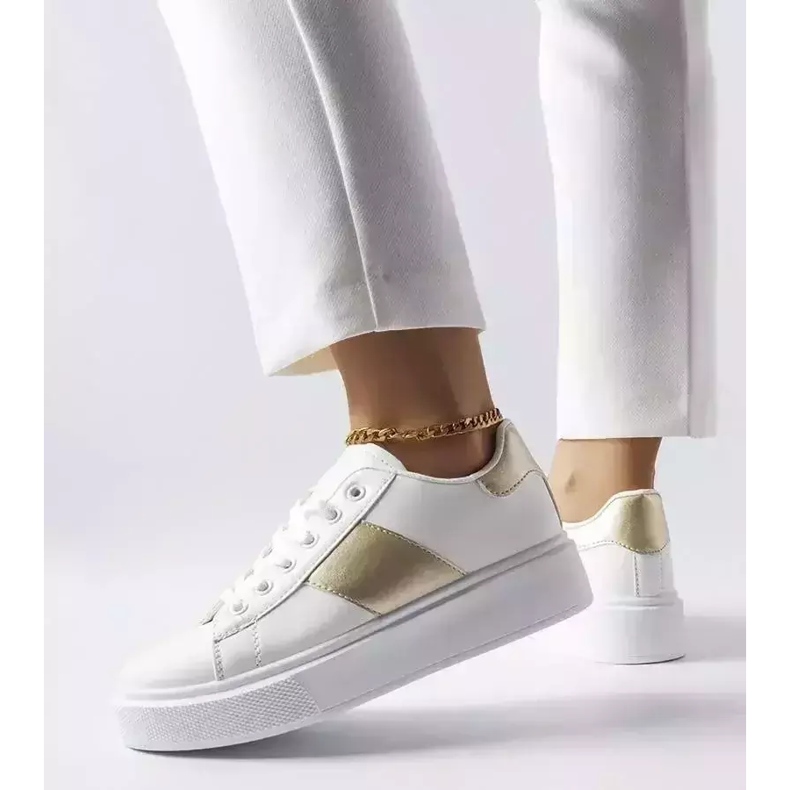 White sneakers with a gold stripe from Aurélie 1