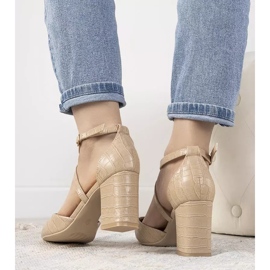 Beige pumps on a Strutt post 1