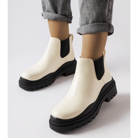 Beige ankle boots on a black platform from Marinone 1