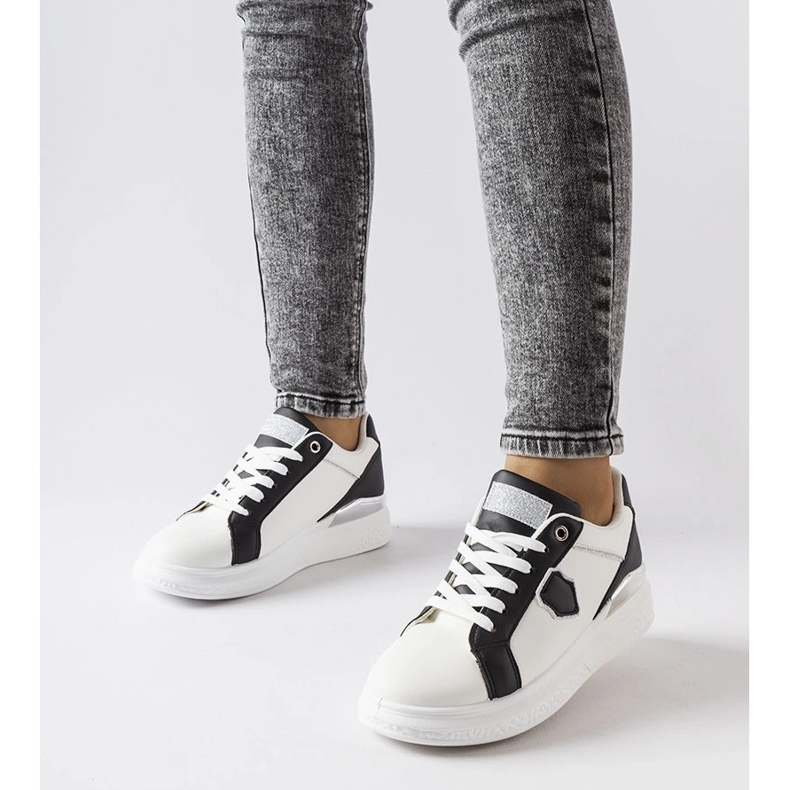 White and black sneakers with a silver accent from Via 1