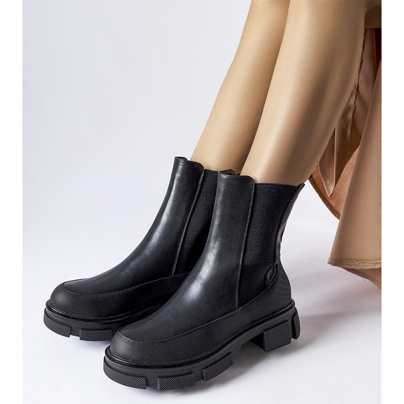 Black ankle boots with an elastic upper by Faisal 1