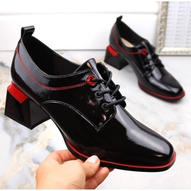 Black patent leather women's shoes on a block by Filippo 1
