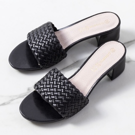 Black woven slippers on the Verdun post 1