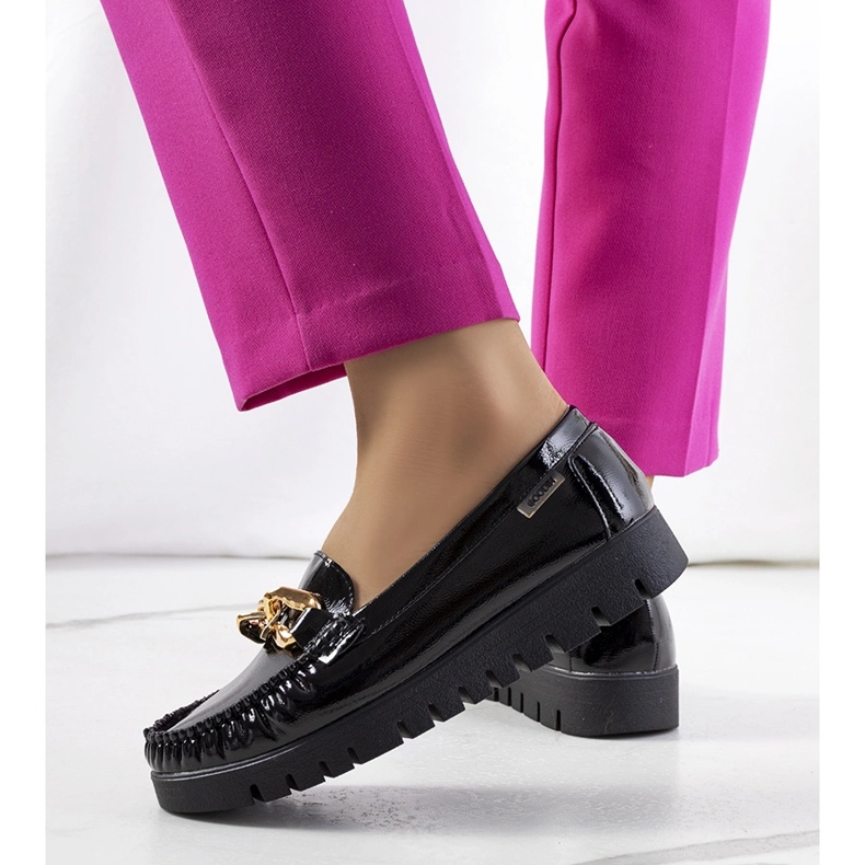 Black loafers on the Travessa platform 1