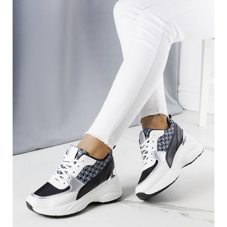 Black sneakers decorated with the Lora monogram 1