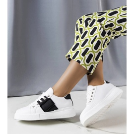 White sneakers decorated with a black Erin buckle 1
