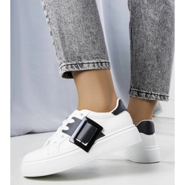 White sneakers decorated with a black Toni buckle 1