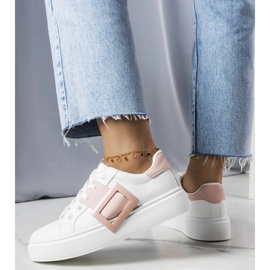 White sneakers decorated with a pink Toni buckle 1